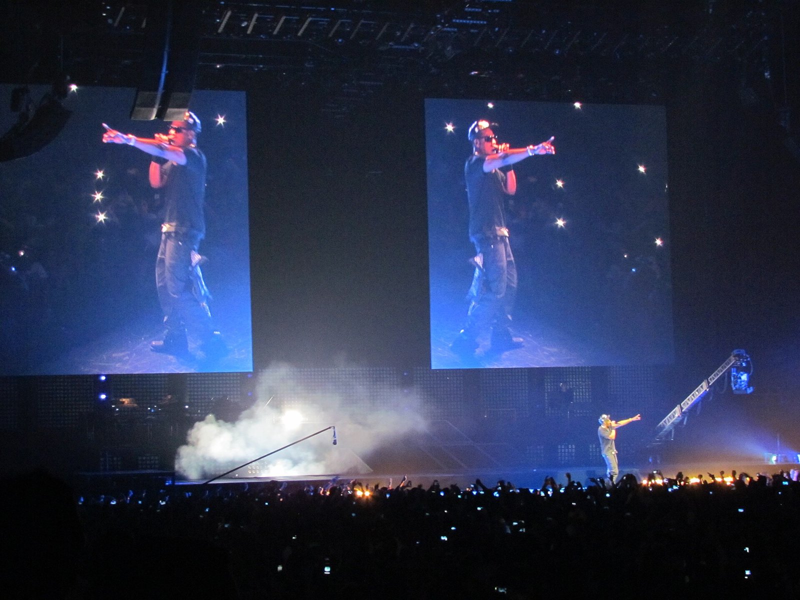 Jay-Z performing alone on stage at The O2 Arena in London, his image projected on giant screens