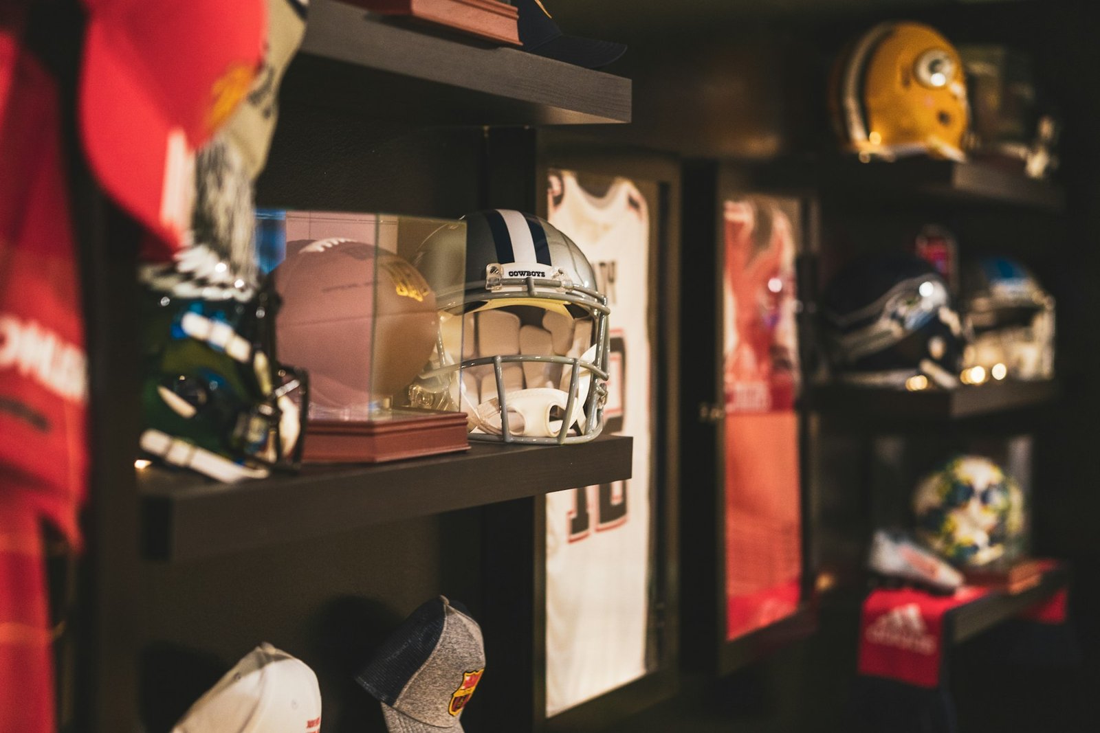 NFL helmets, including a Pittsburgh Steelers helmet, on display