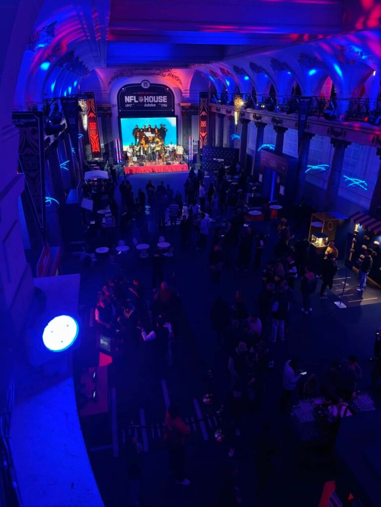 Interior of the Pavillon Cambon during the NFL House event, with the stage, crowd and NFL House sign